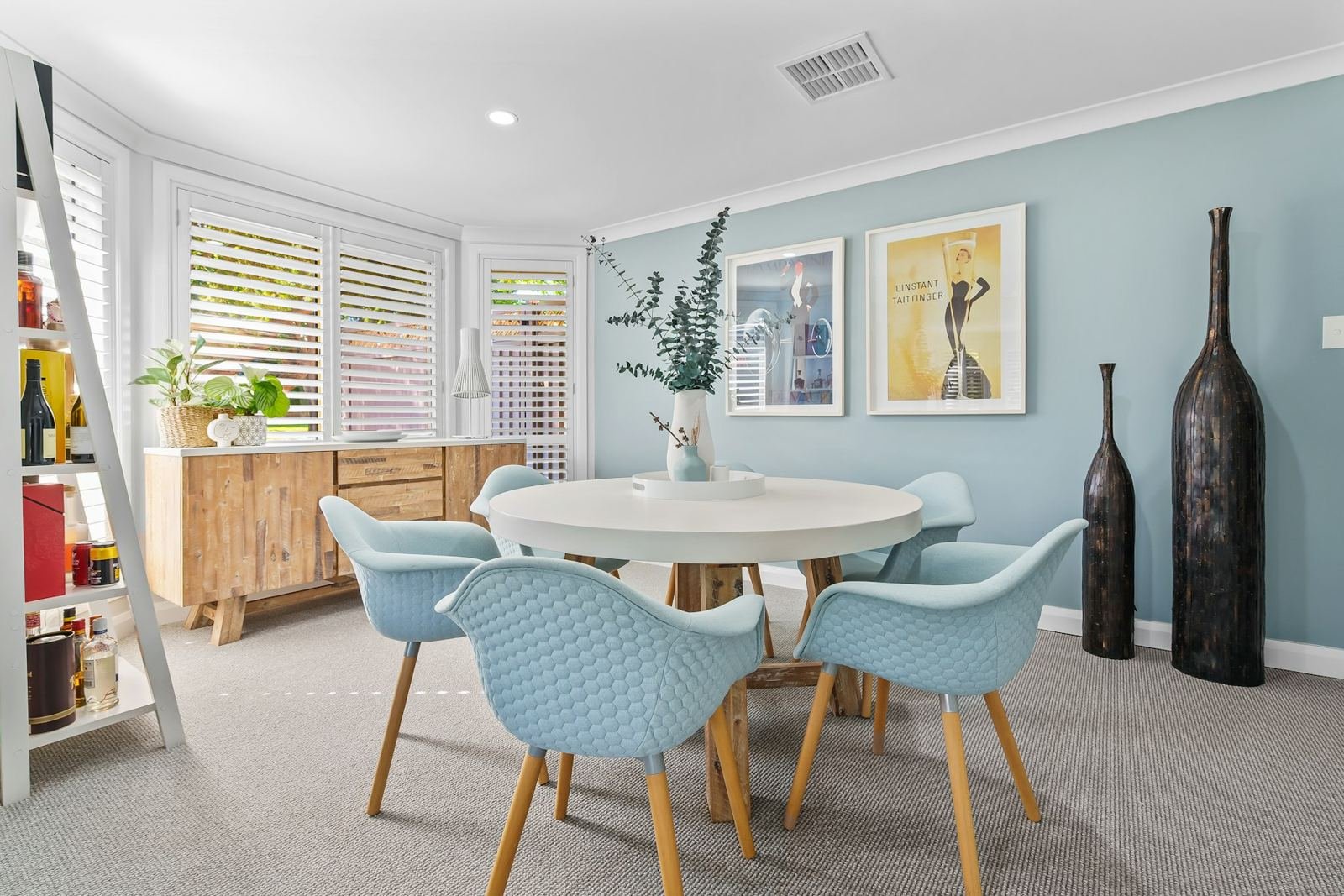 A bright dining nook with pale blue walls